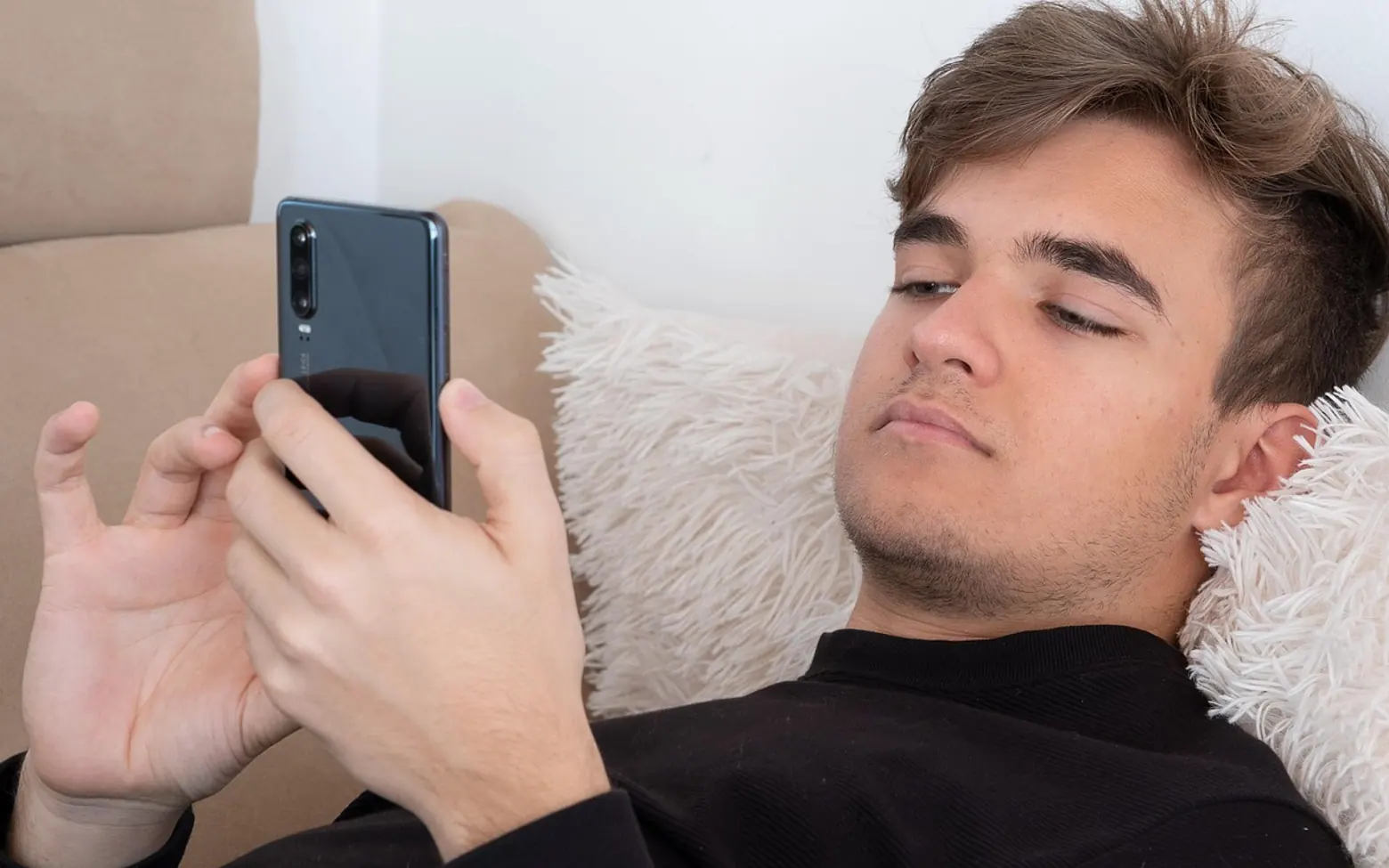 Teenager, sofa and smartphone